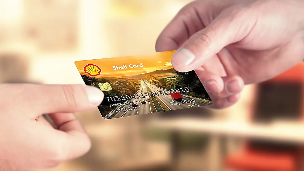 person holding Shell card