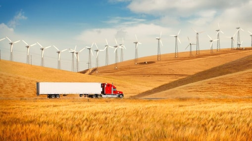 Truck driving through wind farm