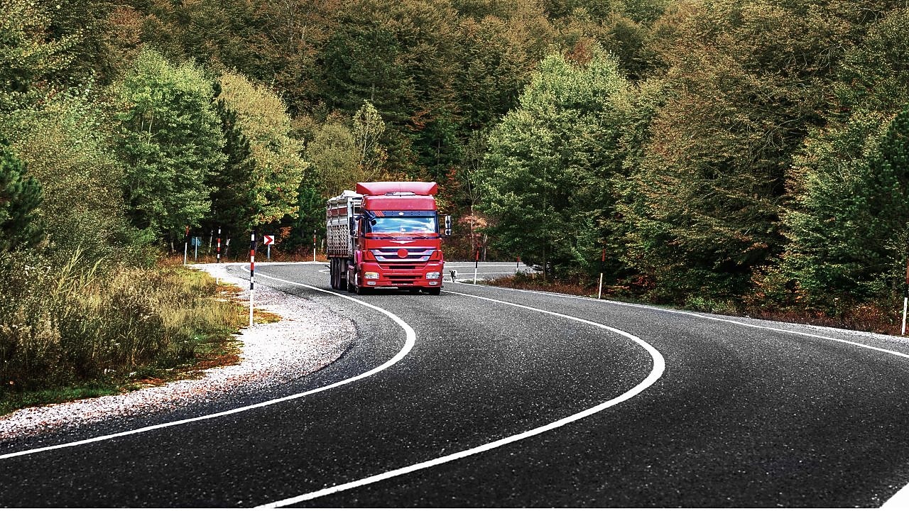 Truck driving through forest