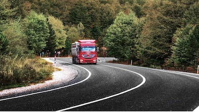 Truck driving through forest