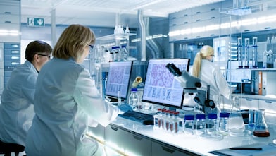 Lab technicians observe chemicals on screens