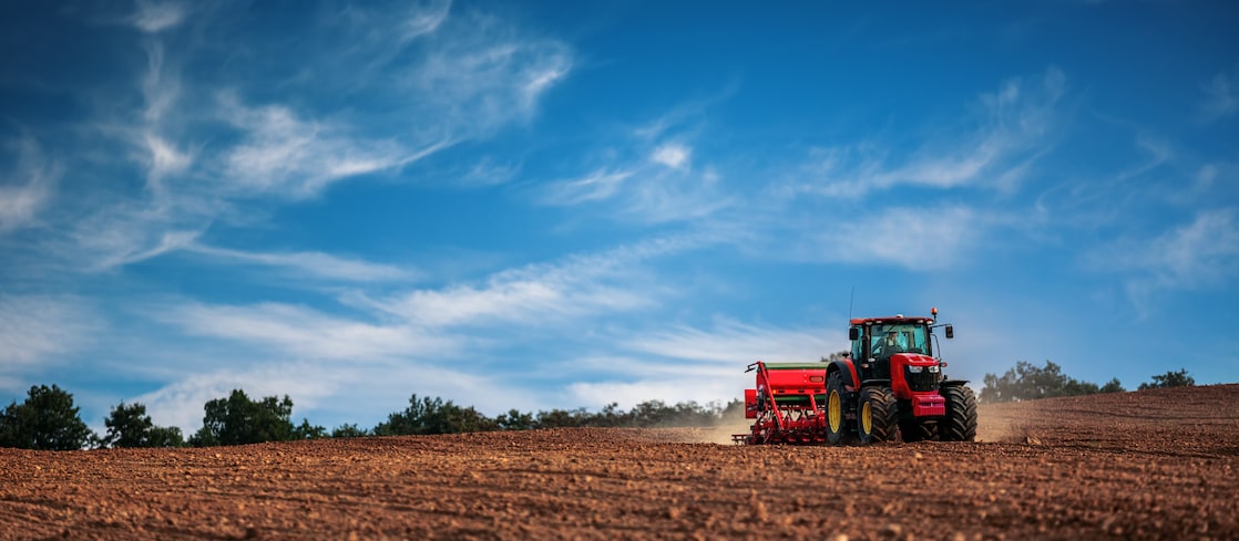 A tractor tilling a field