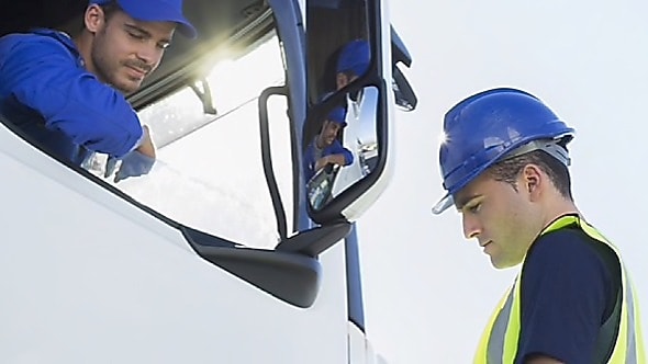 a man talking to a truck driver
