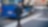 Rear view of mid adult man walking on sidewalk while using mobile phone in city