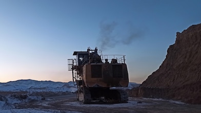 Yellow mining truck in field