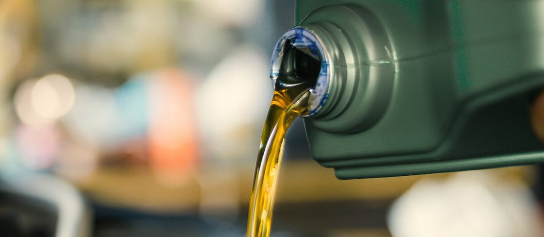 A close up on a lubricant pouring from a bottle