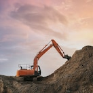 Digger grabbing soil from a hill