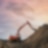 Digger grabbing soil from a hill
