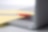 Photo of red pan on yellow piece of paper, placed on the keyboard of a laptop