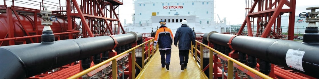 Shell employee walking along on a tanker 