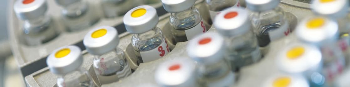 Five beakers in a row with a clear liquid in each one