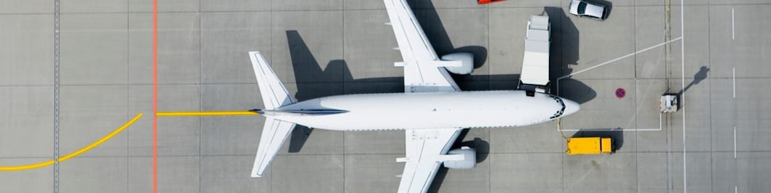 Aerial view of airplane and vans