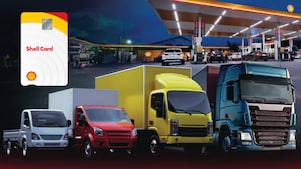 Four trucks with Shell card held up in the foreground