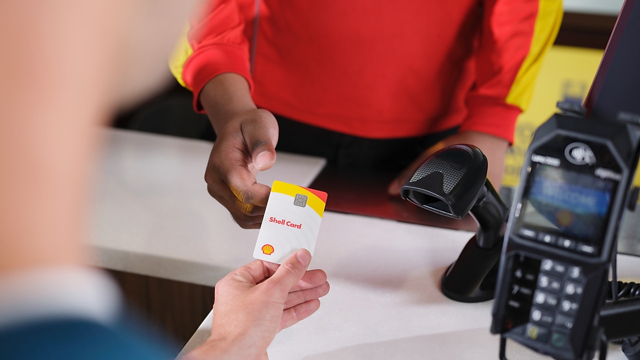 Male Shell customer paying with a Shell card at a Shell retail site.