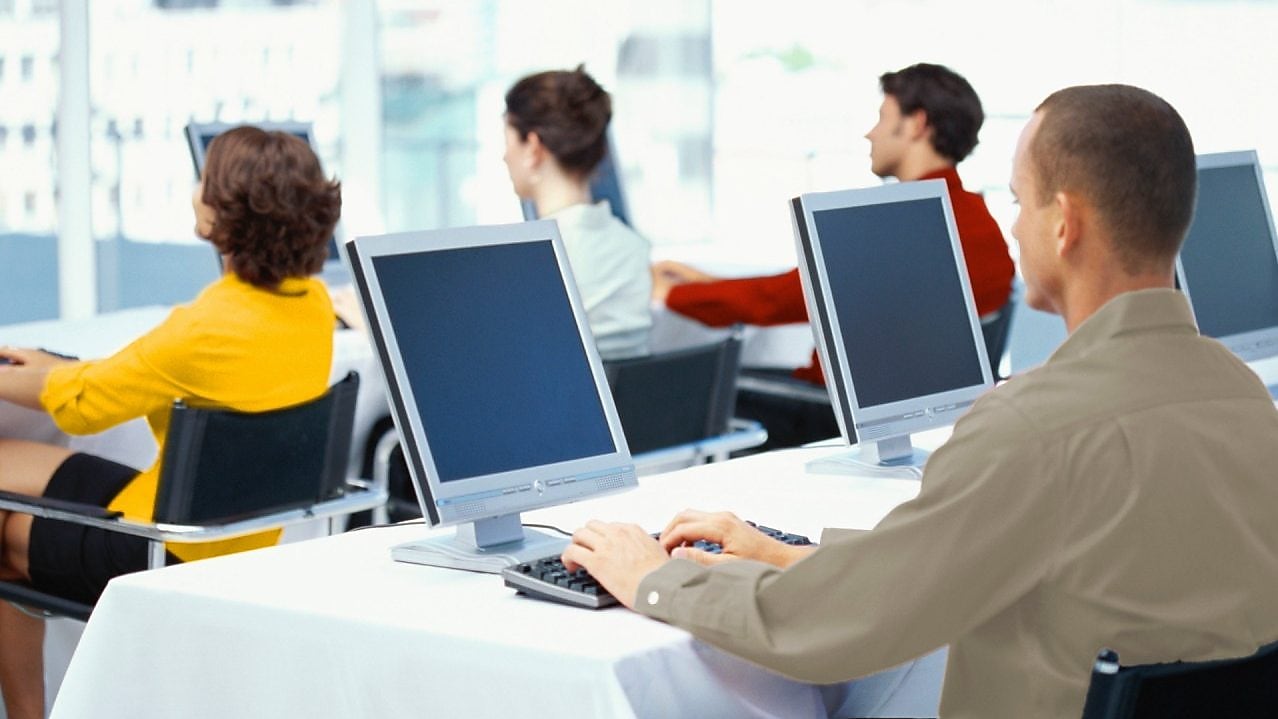 People working and looking at computer monitors