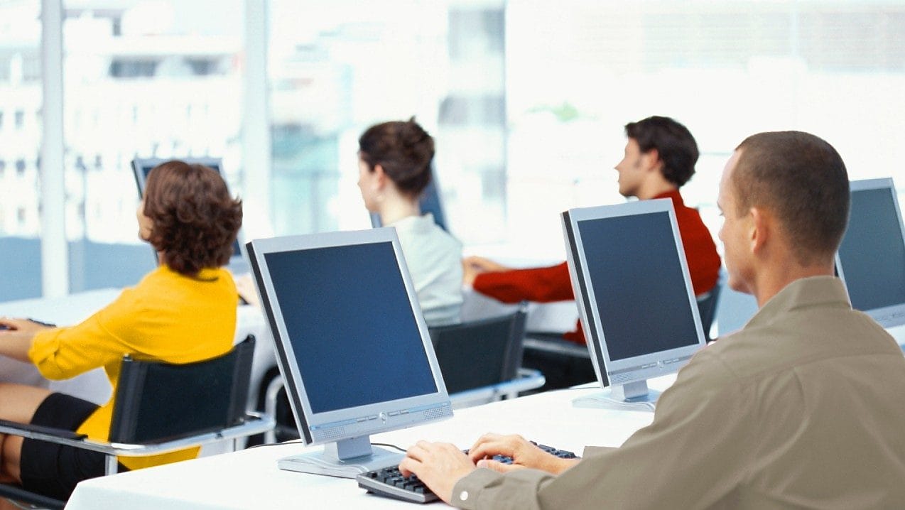 People working and looking at computer monitors