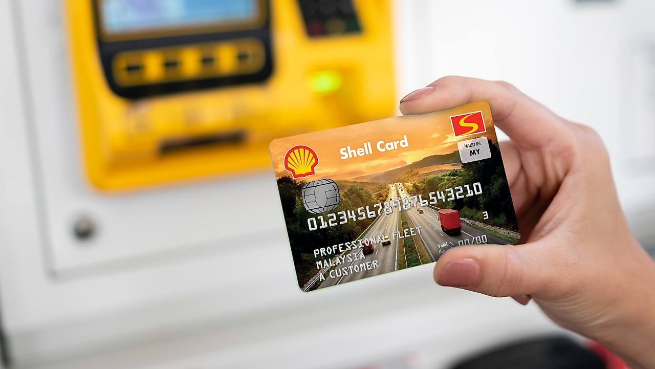 Woman paying at Shell station