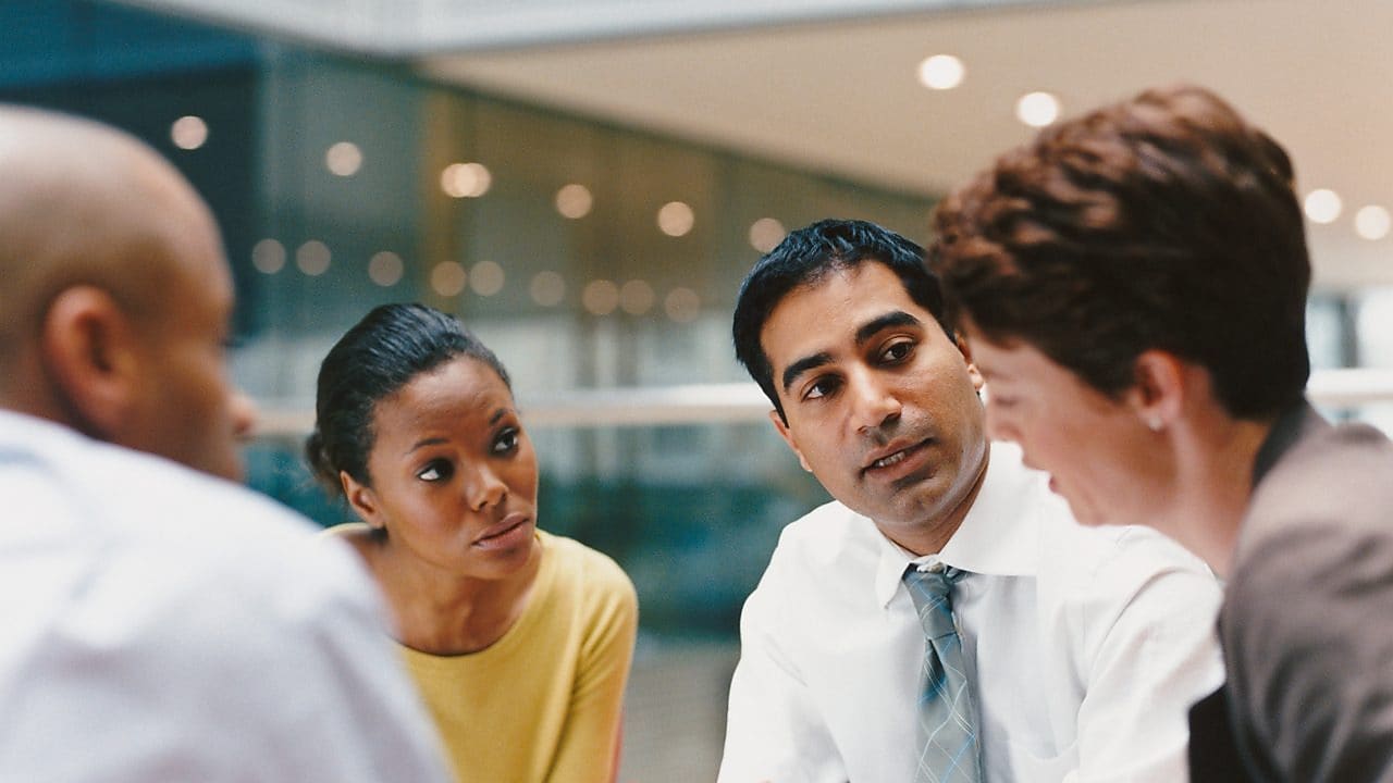 Four smart individuals in the middle of a meeting