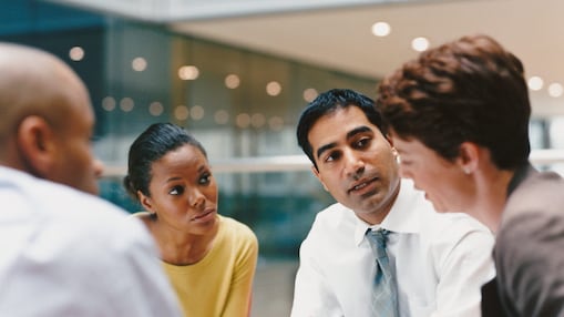 Four smart individuals in the middle of a meeting