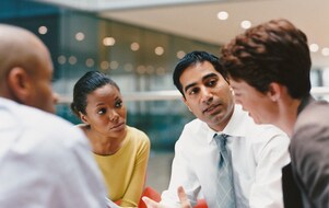 Four smart individuals in the middle of a meeting