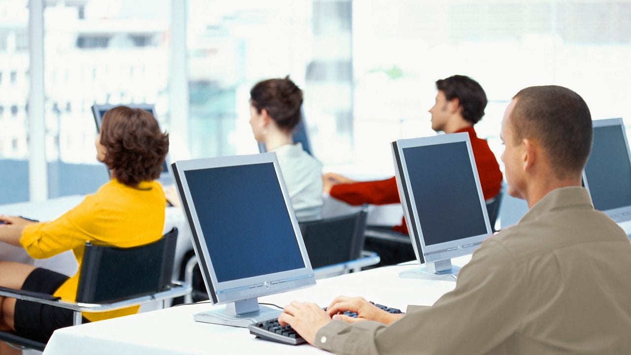 People working and looking at computer monitors