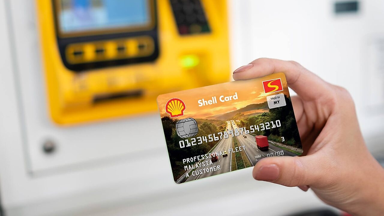 Woman paying at Shell station