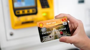 Woman paying at Shell station
