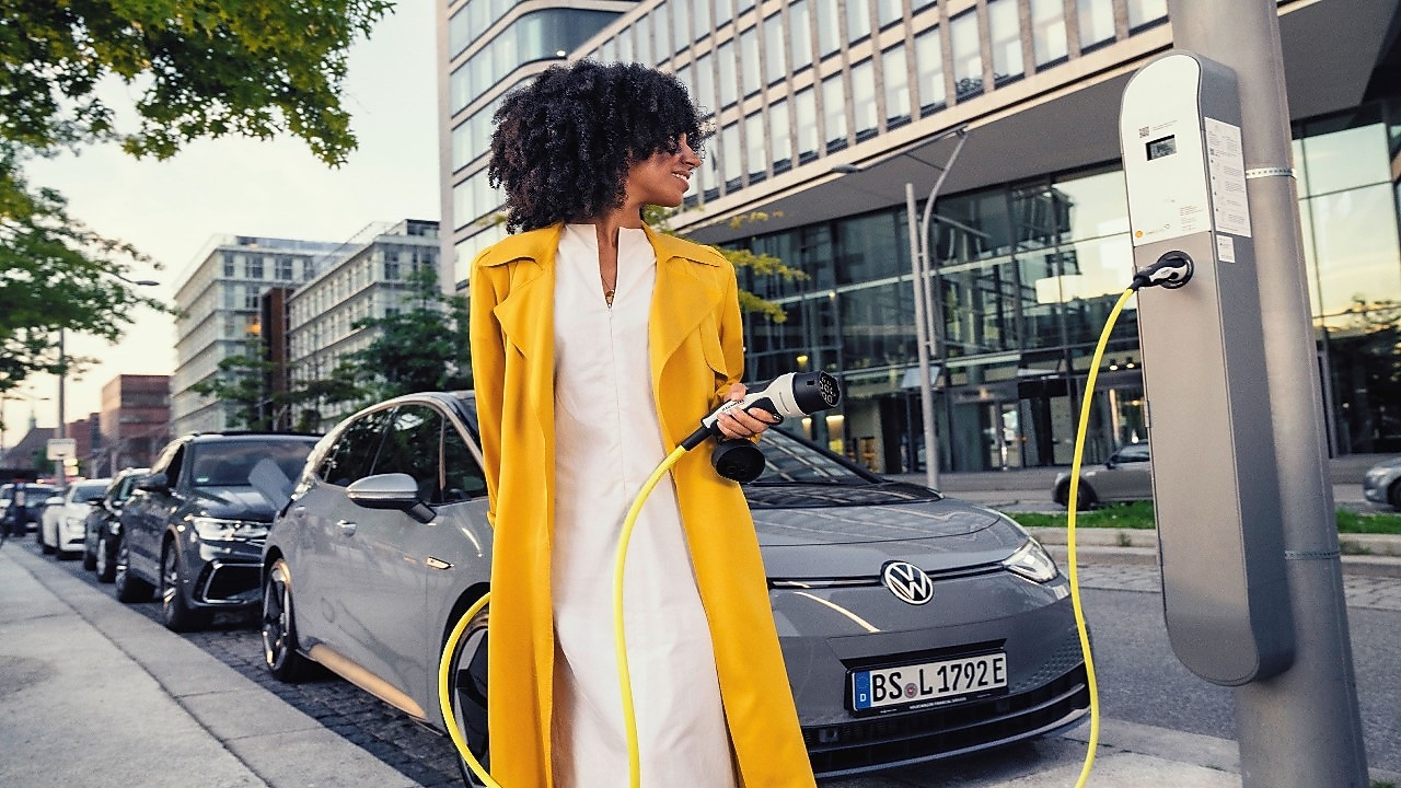 Women standing at shell  ev gas station