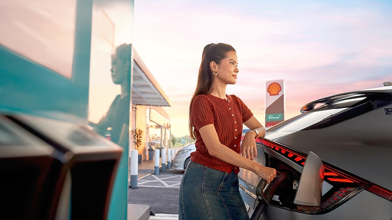 Customer staring into the distance at the Shell Recharge bay.