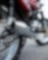 motorcycle parked on road with camera focused on the exhaust and wheels