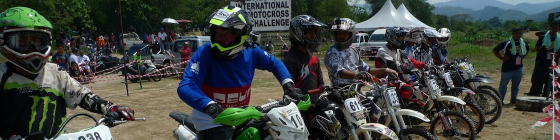 Motorcross motorcycles lining up at the start of a race