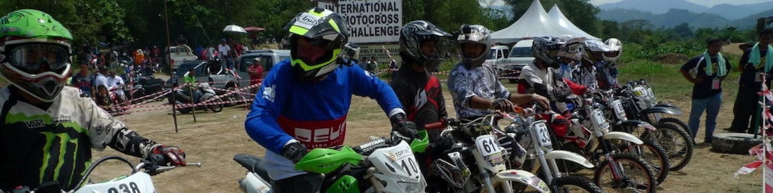 Motorcross motorcycles lining up at the start of a race