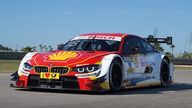 A red and white BMW race car sits on the track, exemplifying the Shell Helix Ultra and BMW’s Premium Technology Partnership