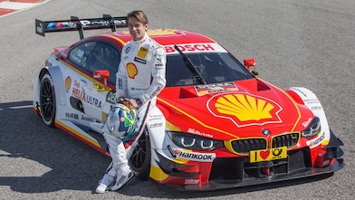 BMW motorsport driver leaning on a car which uses a bespoke Shell Helix oil formulation