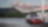 Red car in shell forecourt
