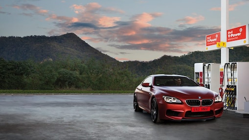 Red car in shell forecourt