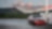 Red car in shell forecourt
