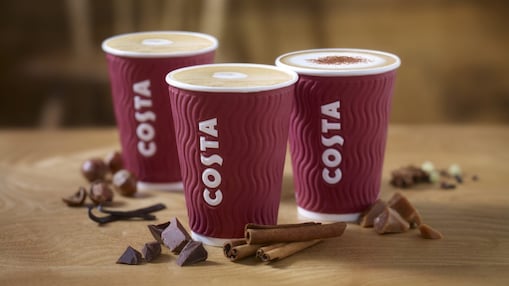Three cups of costa coffee with british themed background