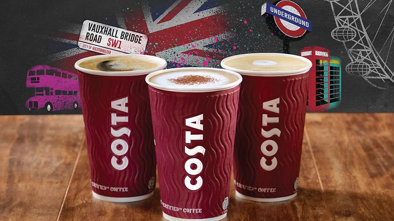 Three cups of costa coffee with british themed background